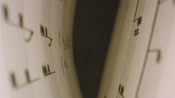 Macro shot through musical notes inside music book, then book opens - Footage, Video