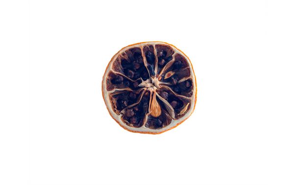 Dried lemon with cloves on a white background - Foto, Imagen
