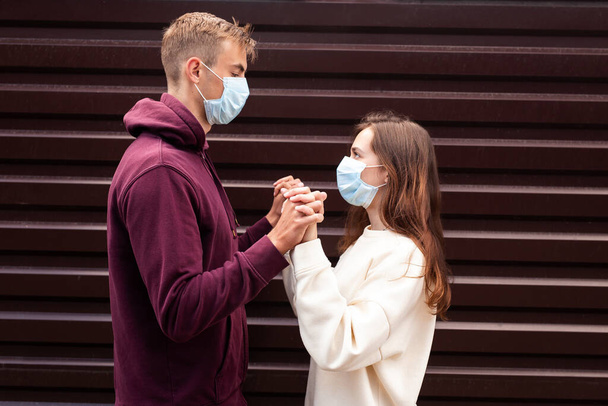 Young man and woman in face mask. Virus outbreak - Fotoğraf, Görsel