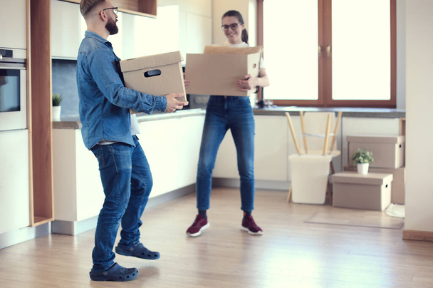 Couple holding boxes for moving the hands and have a dance with boxes - Photo, Image