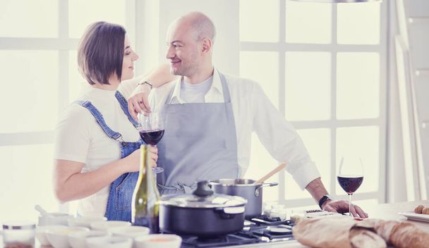 Couple cooking together in the kitchen at home - Foto, Imagem