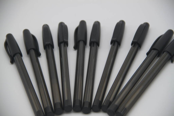 black pens on white background - Foto, Bild