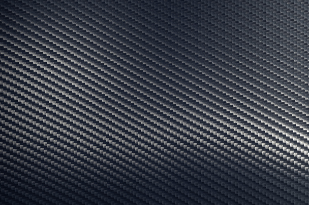 Bended surface of grey woven carbon fibre composite sheet. - Photo, Image