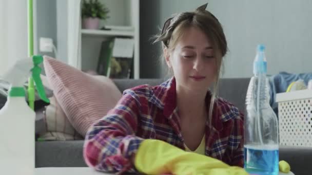 Junge Frau entfernt mit rosa Schwamm Staub vom Tisch - Filmmaterial, Video