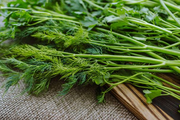 Parsley and dill on a wooden board. - Foto, Imagem