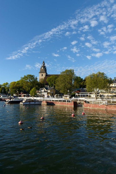 Portrait of harbor with beautiful scenery and Christian church in the background in Naantali Finland - Fotoğraf, Görsel