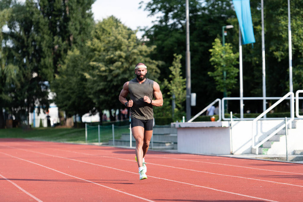 Sporty Man Running Fitness Workout on Track Exercising Outside - Photo, Image