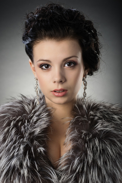 Portrait of a young girl in a fur coat - Photo, Image