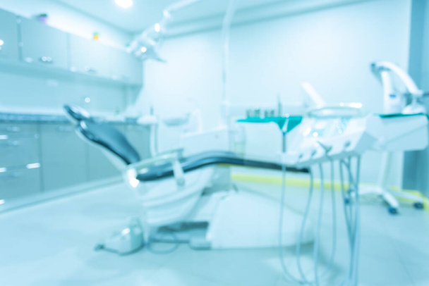 Abstrakcyjne rozmycie Sprzęt dla dentystów, Nowoczesna praktyka stomatologiczna. Fotel dentystyczny i inne akcesoria stosowane przez dentystów w kolorze niebieskim, światło medyczne - Zdjęcie, obraz