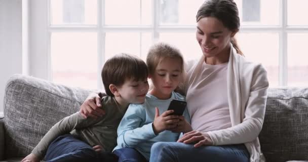 Affectionate mother controlling kids internet technology usage. - Video, Çekim