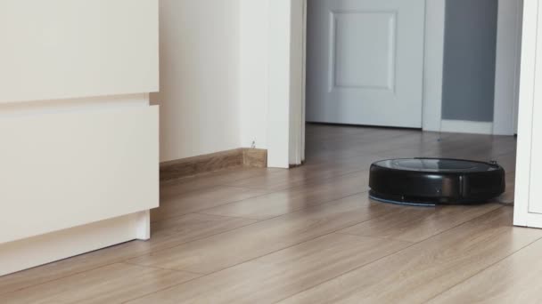 close-up view on a self-moving robotic vacuum on the floor. - Footage, Video