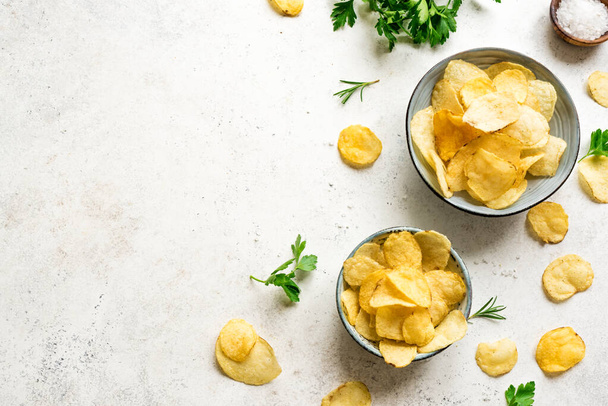 Homemade potato chips in bowls. Crispy potato chips on white background, top view, copy space. - Φωτογραφία, εικόνα