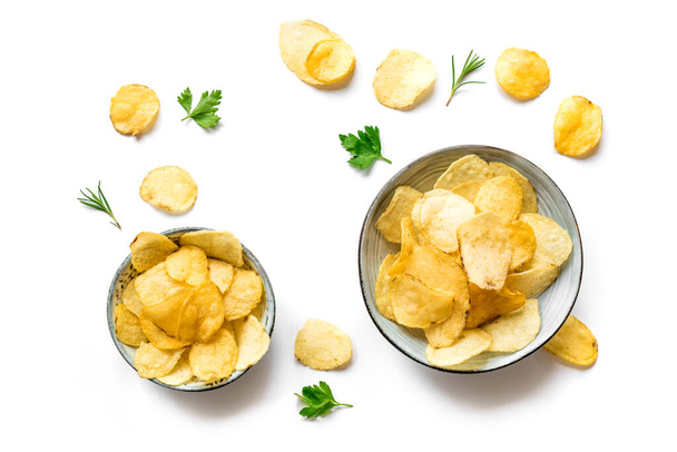 Potato chips in bowls isolated on white background. Homemade oven baked crispy potato chips, top view, copy space. - Φωτογραφία, εικόνα