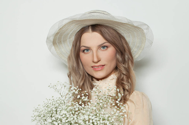 Nice woman in white hat with flowers, beautiful female face - Foto, Imagen