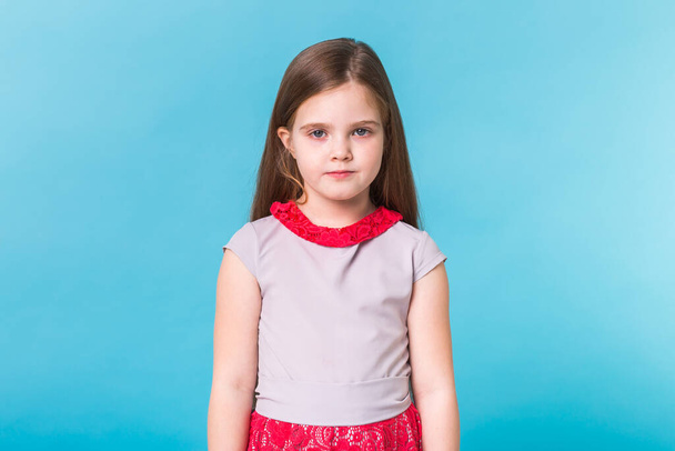 Beautiful little girl isolated on a blue background. Childhood and children concept. - Fotografie, Obrázek