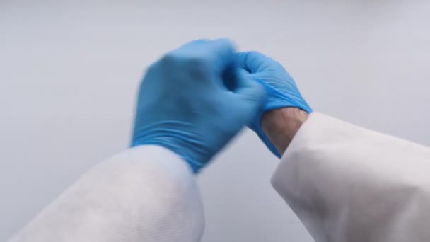 Doctor take off blue latex gloves, closeup. - Felvétel, videó