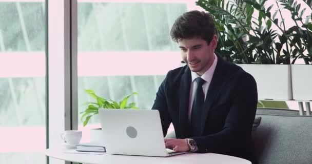 Happy confident millennial employee working on project on laptop. - Video, Çekim