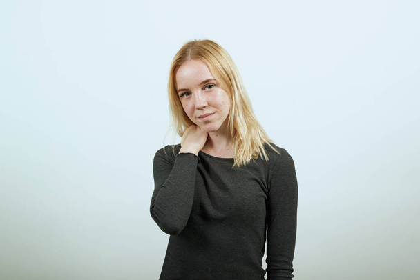 Gentle Girl Looks At Camera Holds Shoulder With Her Hand - Valokuva, kuva