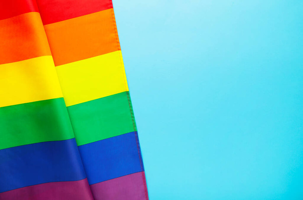 Rainbow LGBT flag on blue background, top view - Foto, Bild