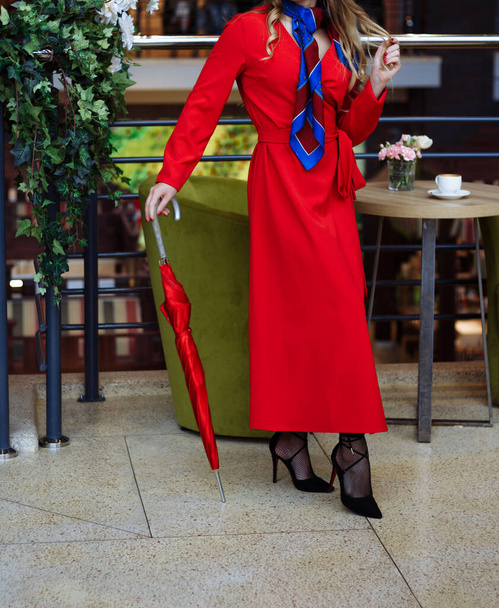 girl in a red coat indoors, cafe, shopping - Photo, Image