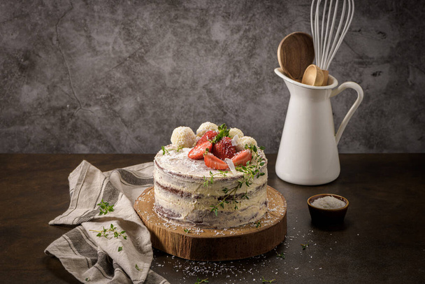 Naked cake with strawberries on kitchen counter top. - Φωτογραφία, εικόνα