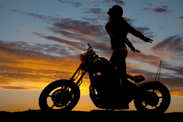 Silhouette woman motorcycle stand hands back - Photo, Image