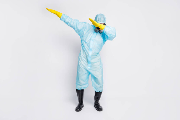 Full length photo of dabber man dance close cover face hands wear white biohazard uniform breathing mask isolated grey color background - Foto, immagini