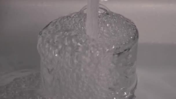 stream of water flowing into a transparent glass in slowmotion - Footage, Video