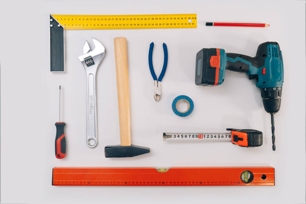 Construction tools on a light background. The concept of using tools to make repairs in an apartment, isolation on a white background - Foto, Imagem