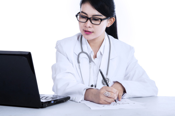 Female doctor writes medical reports - Foto, Imagen