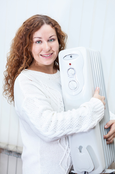 Woman holding new buying radiator - Фото, изображение