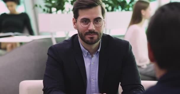 Smart young businessman discussing project with client or partner. - Materiał filmowy, wideo