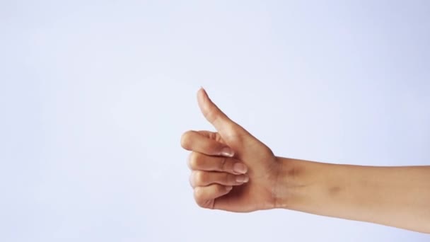 Female hand show thumbs up gesture. Woman hand rise OK, good sign closeup isolated at white screen background - 映像、動画
