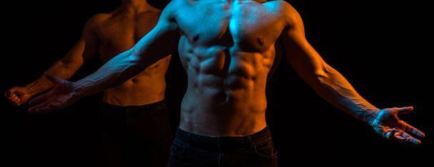 Muscular young man in black tank-top showing abs. Men abs. Fitness abdominal muscle. Man six pack. - Photo, Image