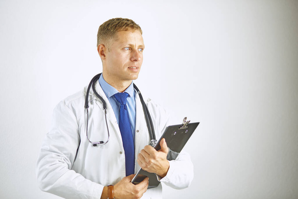 Young confident doctor in a white coat with a stethoscope - Fotoğraf, Görsel