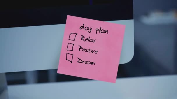 Day plan. The inscription on the sticker on the monitor. Message. Motivation. Reminder. Handwritten text written with a marker. Color sticker. A message for an employee, a colleague. Work remotely. - Footage, Video