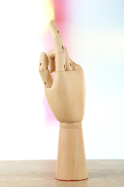 Wooden hand on light background - Photo, Image