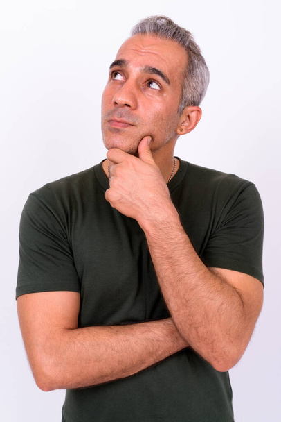 Studio shot of handsome Persian man against white background - Photo, Image