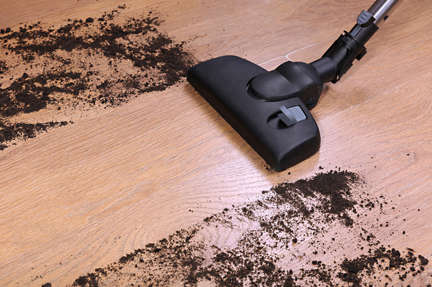 Vacuuming floor in house - 写真・画像