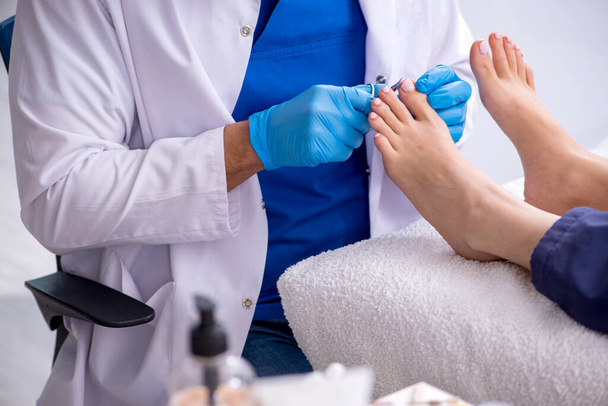 Podiatrist treating feet during procedure - Photo, Image