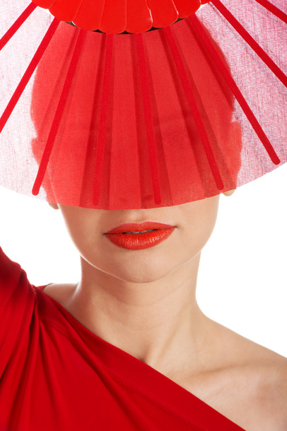 Beautifull woman in sexy red dress with fan. - Fotó, kép