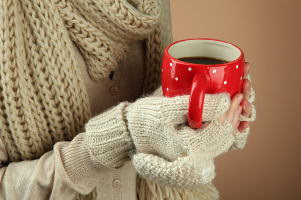 Female hands with hot drink, on color background - Foto, Imagem