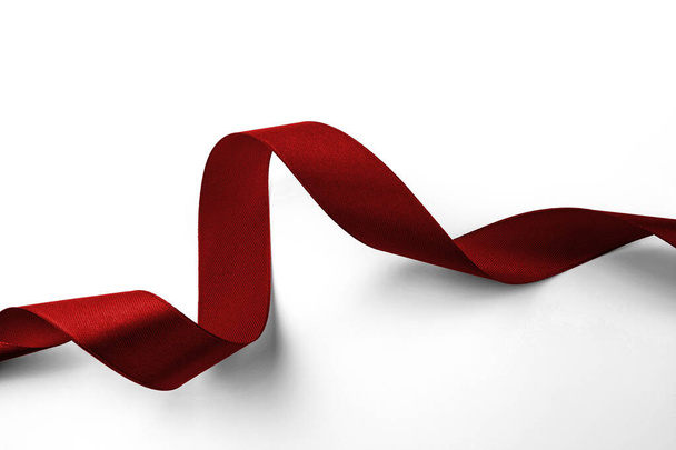 Shiny red ribbon on white background with copy space. - Φωτογραφία, εικόνα