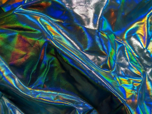 Holographic iridescent foil texture background. Futuristic vibrant neon trendy mermaid silver colors - Photo, Image