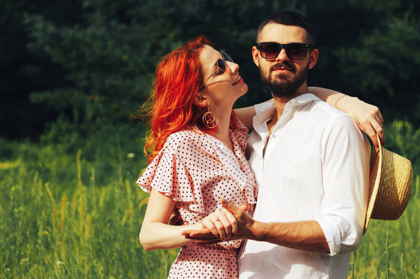 happy, couple in love cuddling, Redhead girl. minute to kiss. date attraction and sexuality sunglasses in summer - 写真・画像