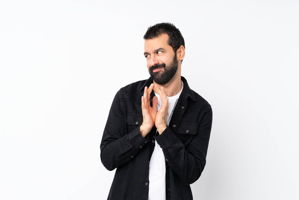 Young man with beard over isolated white background scheming something - Φωτογραφία, εικόνα