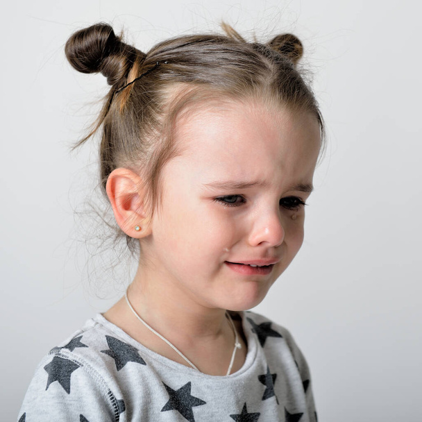 Crying little girl. Upset kid. Sad kid portrait. Cute little gilr crying and does not want to go in bed at night - Foto, immagini