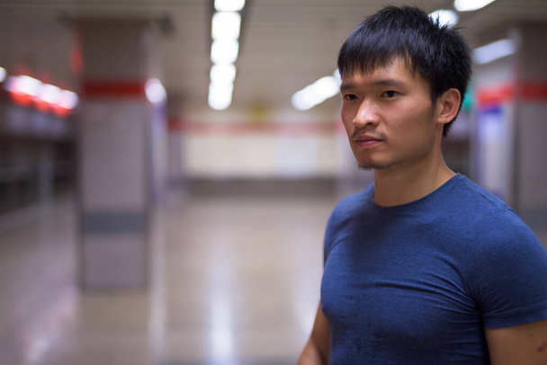 Portrait of young Chinese man at the subway station in the city - Fotoğraf, Görsel