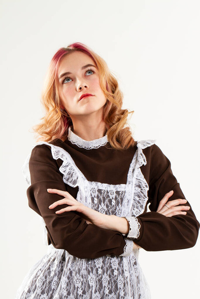 blonde in a school uniform. Studio portrait on a white background - Zdjęcie, obraz