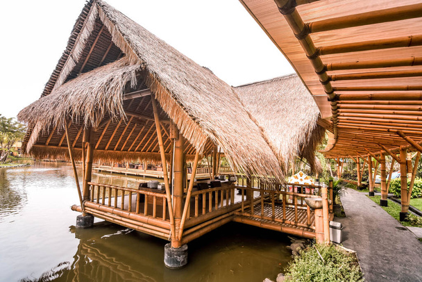 Surabaya, Indonésie - 28 mars 2019 : L'atmosphère à l'intérieur du restaurant, le bâtiment fait par le bambou au-dessus de l'étang de poissons nommé Gubug Makan Mang Eking, à Juanda Surabaya, Java Est, Indonésie
 - Photo, image